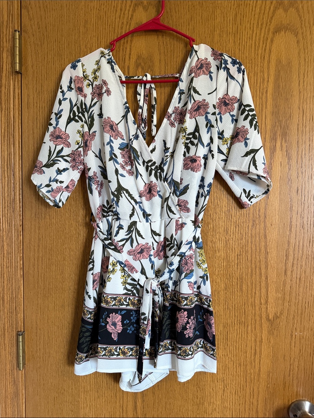 Francesca's Collections White Floral Wrap Romper with Pink and Blue Accents